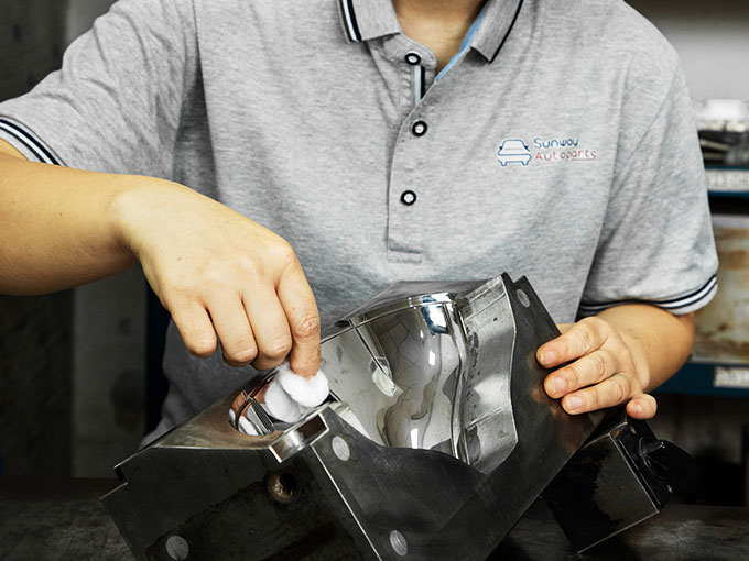 The worker perform hands on polishing to achieve top quality for auto part